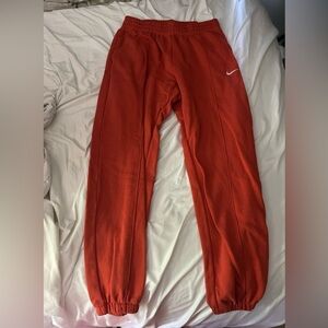 Orange Nike sweatpants, size women’s M